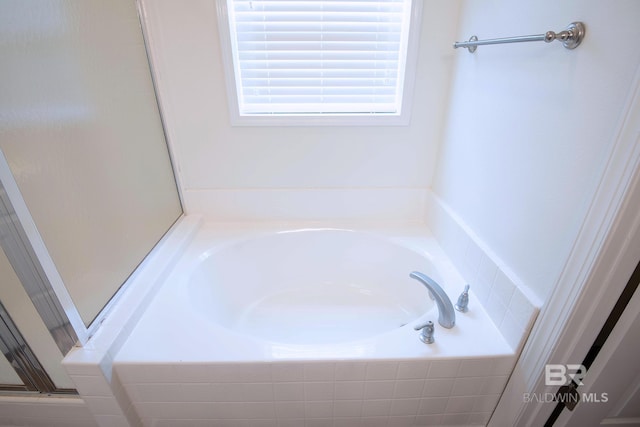 bathroom featuring tiled bath