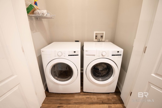 laundry area with dark wood-type flooring and washer and dryer