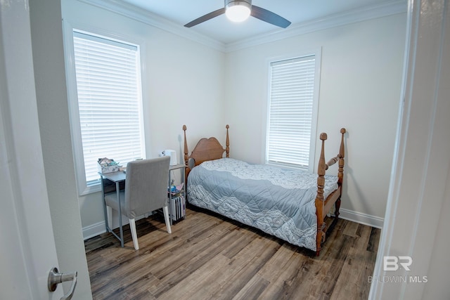 bedroom featuring multiple windows, ceiling fan, and hardwood / wood-style flooring