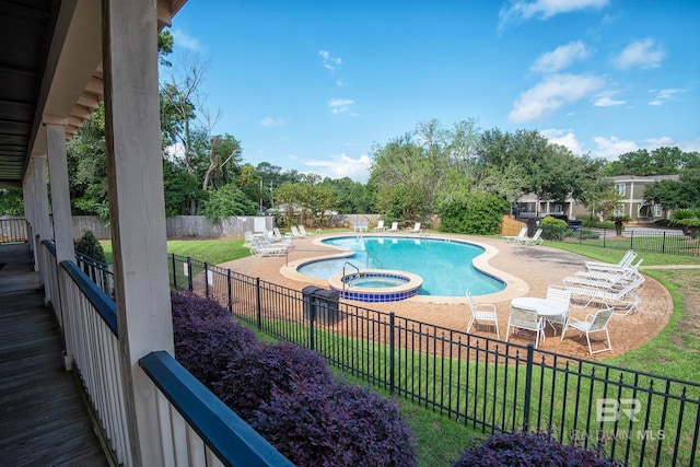 view of pool with a lawn, a patio, and a community hot tub