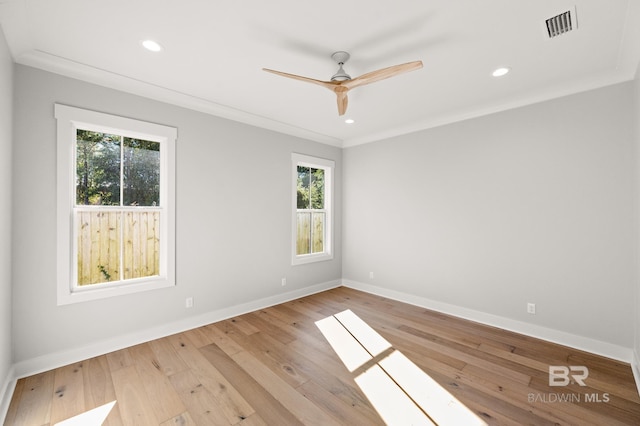 empty room featuring light wood-type flooring, ceiling fan, and ornamental molding