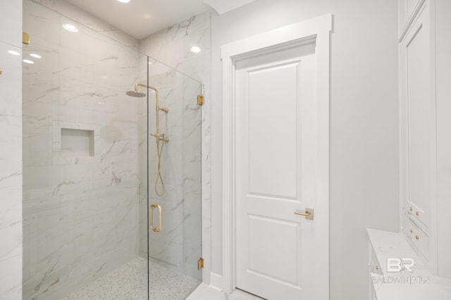 bathroom featuring a shower with shower door