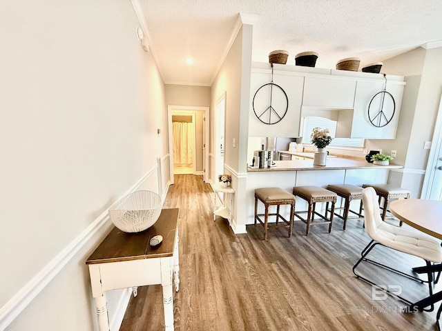 33 Cottage Dr, Fairhope, AL 36532 - hall with crown molding, wood finished floors, and a textured ceiling