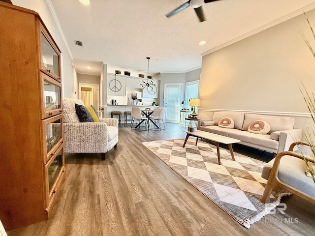 33 Cottage Dr, Fairhope, AL 36532 - living room with ornamental molding, wood finished floors, ceiling fan, recessed lighting, and a textured ceiling