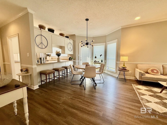 33 Cottage Dr, Fairhope, AL 36532 - dining space with a chandelier, dark wood-style flooring, ornamental molding, and a textured ceiling