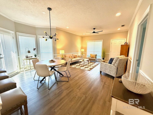 33 Cottage Dr, Fairhope, AL 36532 - dining space with wood finished floors, a textured ceiling, plenty of natural light, crown molding, and recessed lighting