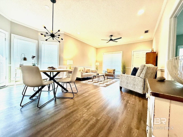 33 Cottage Dr, Fairhope, AL 36532 - dining room featuring crown molding, dark wood finished floors, a textured ceiling, a ceiling fan, and a chandelier