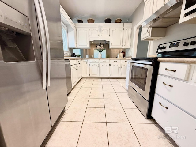 33 Cottage Dr, Fairhope, AL 36532 - kitchen featuring stainless steel appliances, under cabinet range hood, light tile patterned flooring, white cabinets, and light countertops