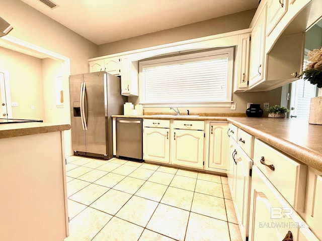 33 Cottage Dr, Fairhope, AL 36532 - kitchen featuring stainless steel appliances, light tile patterned floors, and light countertops