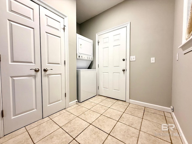 33 Cottage Dr, Fairhope, AL 36532 - laundry room featuring stacked washing machine and dryer and light tile patterned floors
