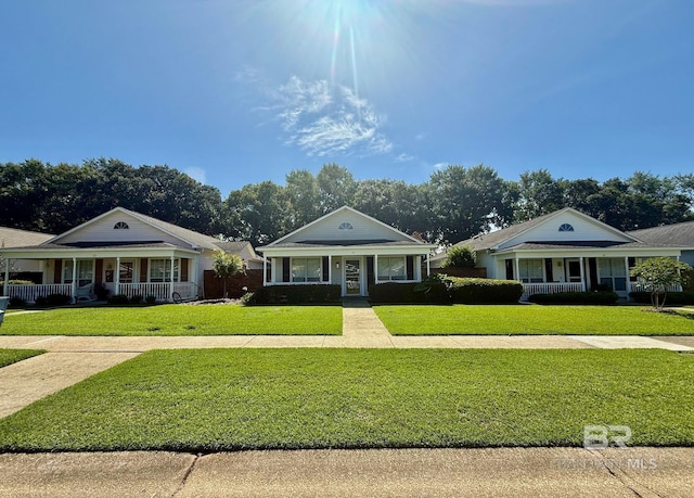 33 Cottage Dr, Fairhope, AL 36532 - greek revival inspired property featuring a porch and a front lawn