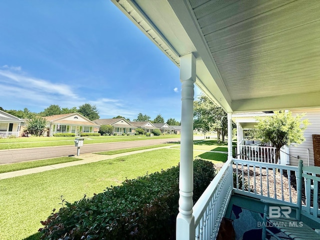 33 Cottage Dr, Fairhope, AL 36532 - view of green lawn with a porch and a residential view