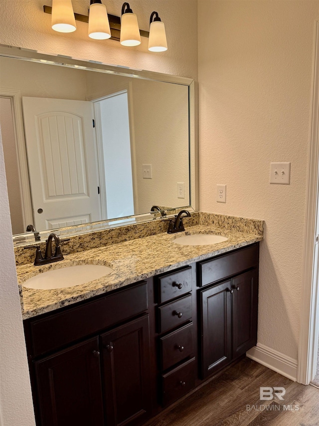 bathroom with vanity and wood-type flooring