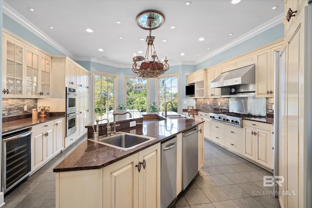 kitchen featuring stainless steel appliances, sink, range hood, wine cooler, and an island with sink