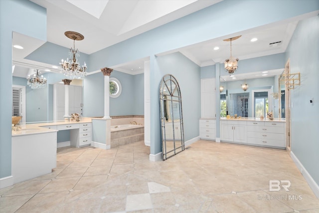 bathroom with vaulted ceiling with skylight, vanity, crown molding, and tiled tub