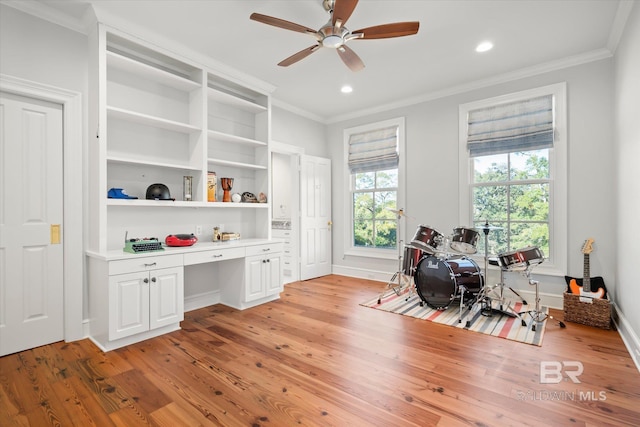 office featuring ceiling fan, light wood-type flooring, and ornamental molding