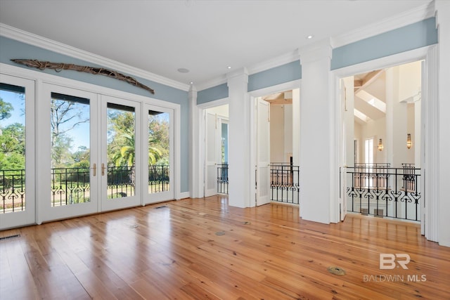 interior space featuring french doors, ornamental molding, and wood-type flooring