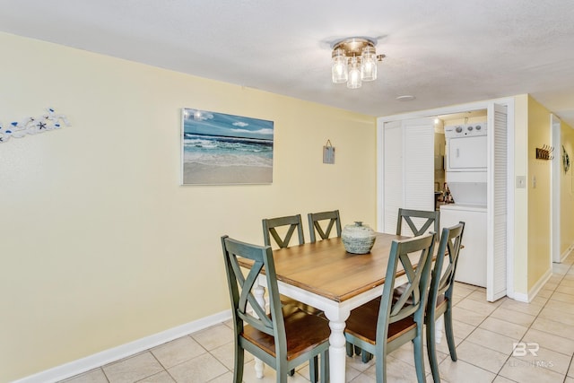 24160 Perdido Beach Blvd Unit 2073, Orange Beach, AL 36561 - dining room with a textured ceiling, stacked washing maching and dryer, and light tile patterned flooring