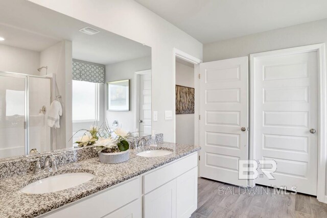 22120 Early Dawn Cir, Foley, AL 36535 - full bathroom with a stall shower, double vanity, and wood finished floors