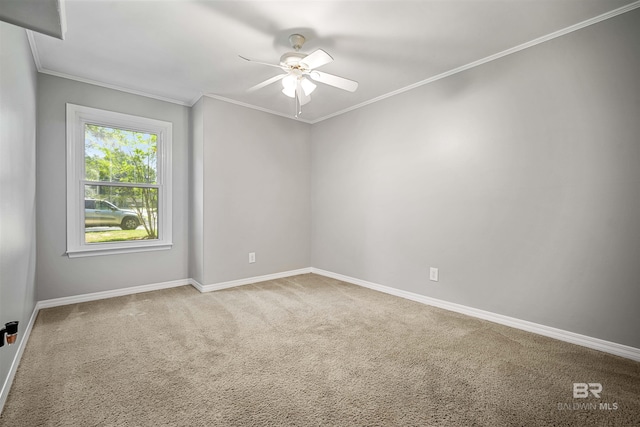 spare room with ornamental molding, ceiling fan, and light colored carpet