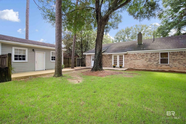 view of yard with french doors and a patio area