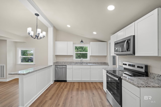1096 S Pine St, Loxley, AL 36551 - kitchen featuring stainless steel appliances, a peninsula, light wood-style flooring, white cabinetry, and recessed lighting