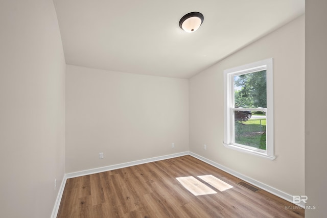 1096 S Pine St, Loxley, AL 36551 - empty room with lofted ceiling and wood finished floors