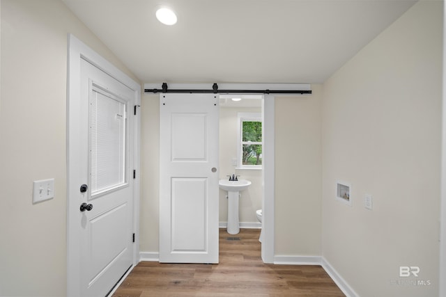 1096 S Pine St, Loxley, AL 36551 - corridor with light wood finished floors and a barn door