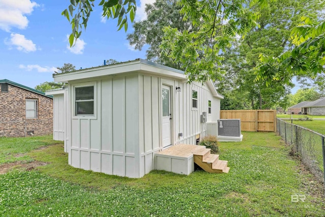 1096 S Pine St, Loxley, AL 36551 - view of property exterior with board and batten siding, a fenced backyard, and an outdoor structure