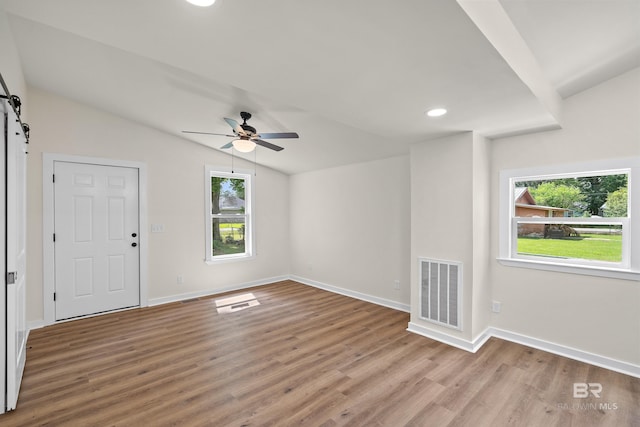 1096 S Pine St, Loxley, AL 36551 - foyer entrance with a barn door, lofted ceiling, healthy amount of natural light, light wood-type flooring, and a ceiling fan