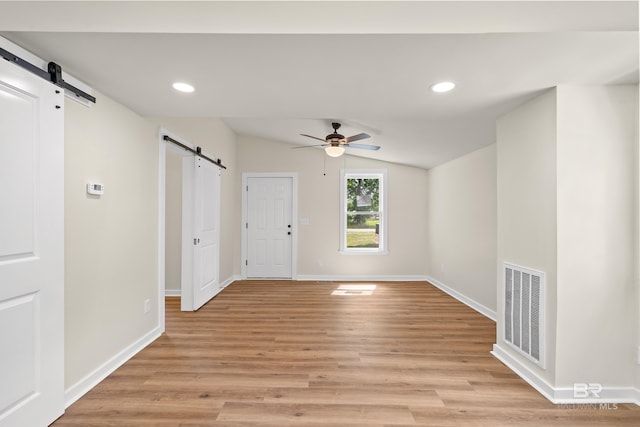 1096 S Pine St, Loxley, AL 36551 - unfurnished room featuring a barn door, ceiling fan, lofted ceiling, recessed lighting, and light wood-style flooring