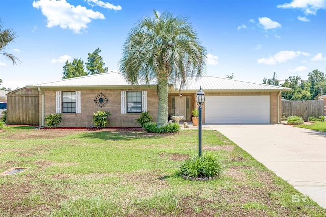 single story home featuring a garage and a front lawn