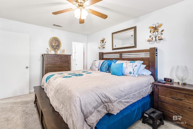 bedroom with ceiling fan and light colored carpet