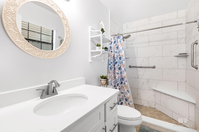 bathroom featuring vanity, curtained shower, and toilet