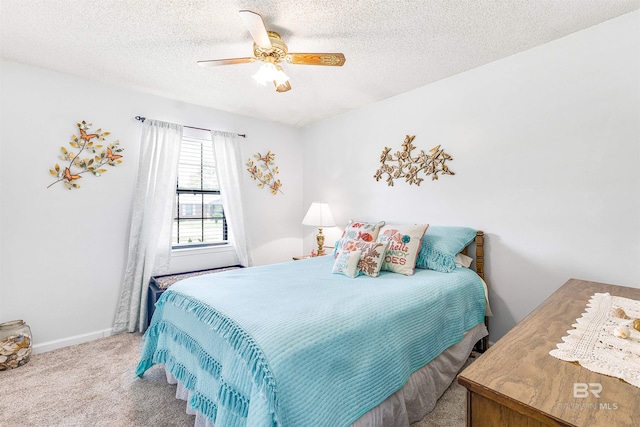 bedroom featuring ceiling fan, carpet, and a textured ceiling