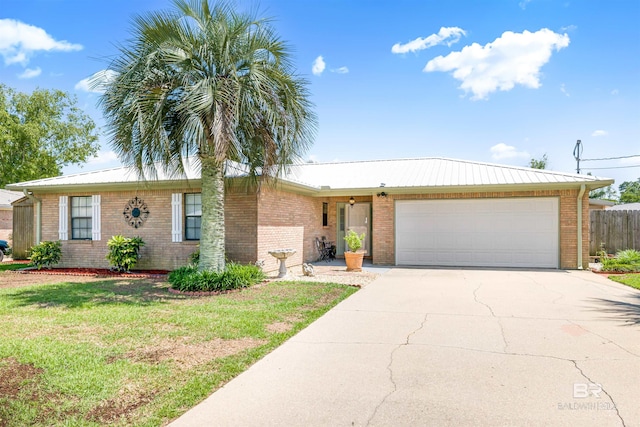 single story home featuring a garage and a front yard