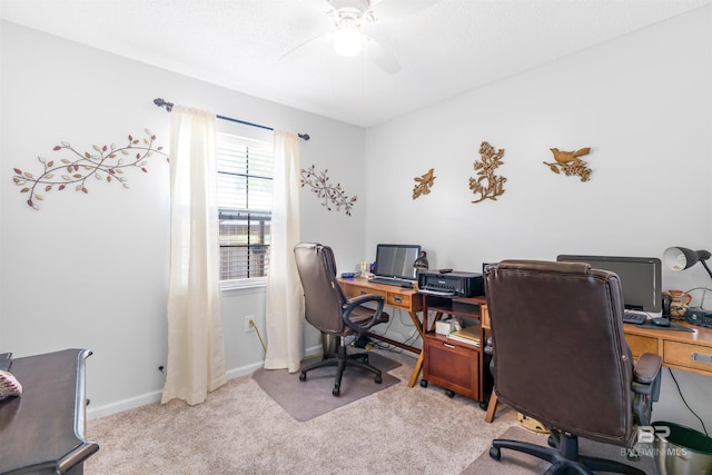 carpeted home office featuring ceiling fan