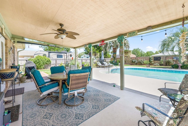 view of patio featuring ceiling fan and a fenced in pool