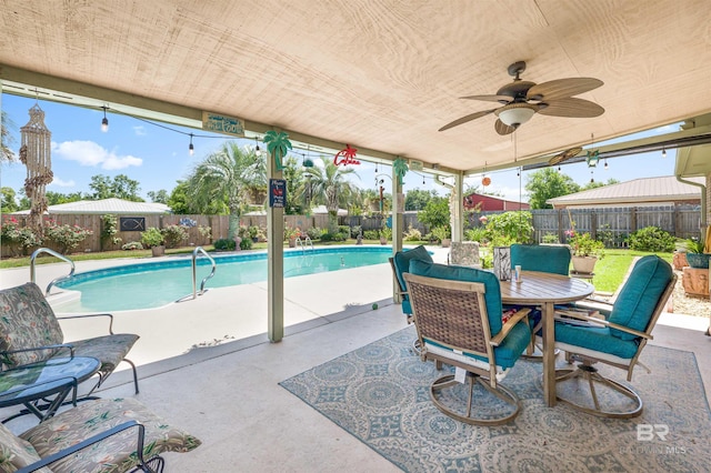 view of swimming pool with ceiling fan and a patio