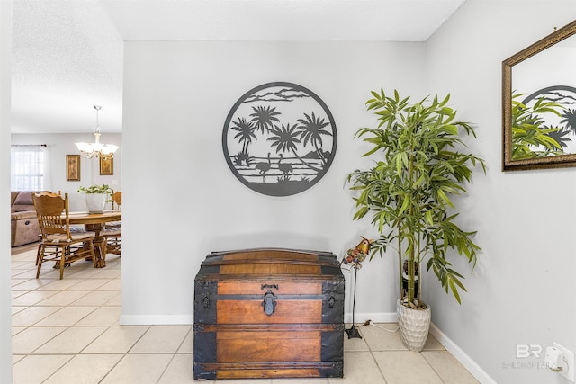 room details with an inviting chandelier and a textured ceiling