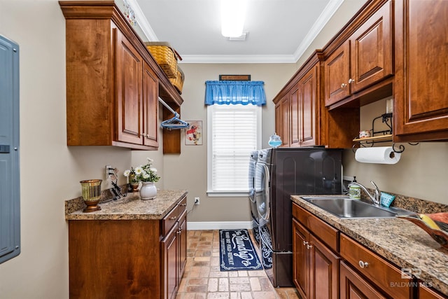 laundry area with crown molding, cabinets, and sink