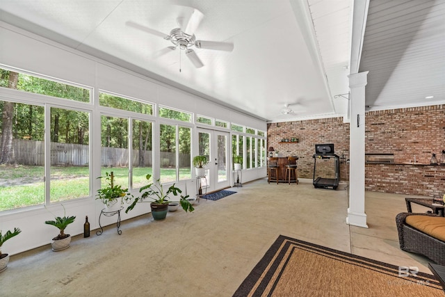 unfurnished sunroom with ceiling fan