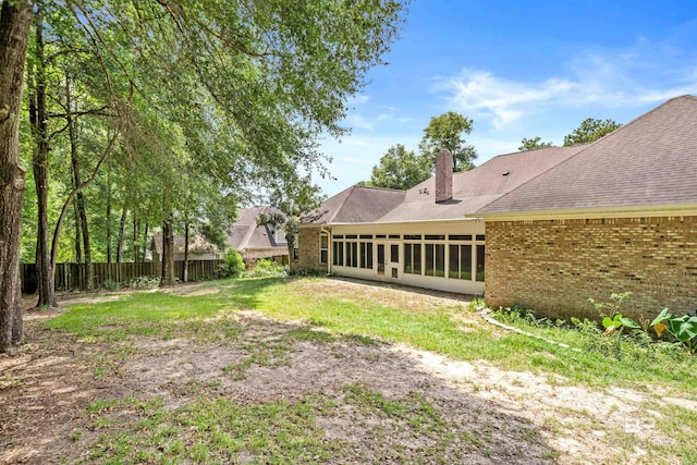 view of yard with a sunroom