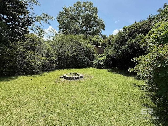 215 W Palm Ave, Foley, AL 36535 - view of green lawn with an outdoor fire pit