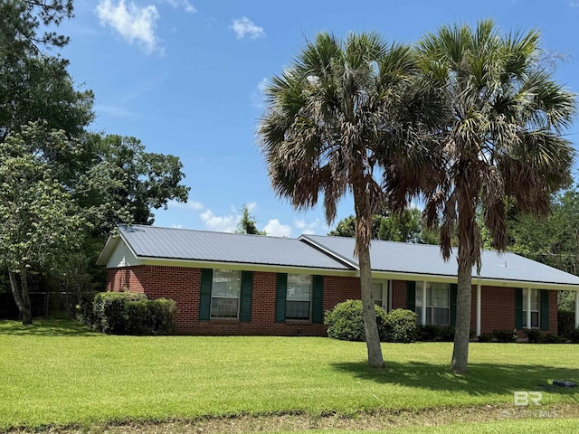 215 W Palm Ave, Foley, AL 36535 - ranch-style home featuring a front yard, brick siding, and a metal roof