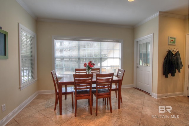 dining room featuring crown molding, plenty of natural light, and baseboards