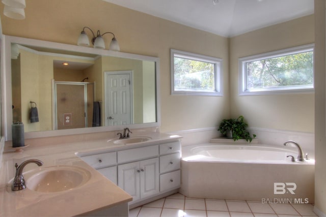 full bathroom with a stall shower, a sink, a bath, and double vanity