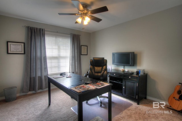 home office featuring a ceiling fan, light colored carpet, and baseboards