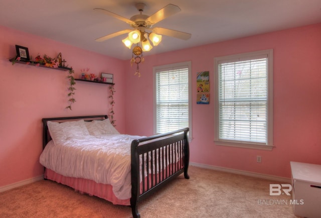 bedroom with light carpet, ceiling fan, and baseboards