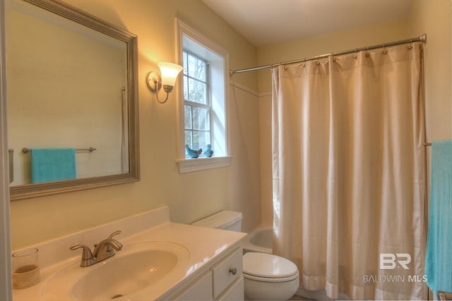 full bathroom with toilet, vanity, and shower / tub combo with curtain